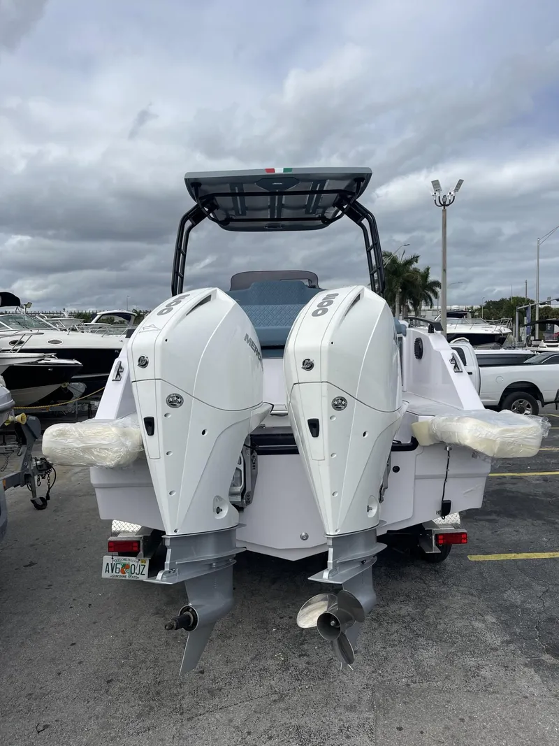 Slide: The Image of 2024 Ranieri 275 SL boat on a trailer in a marina parking lot. - 12