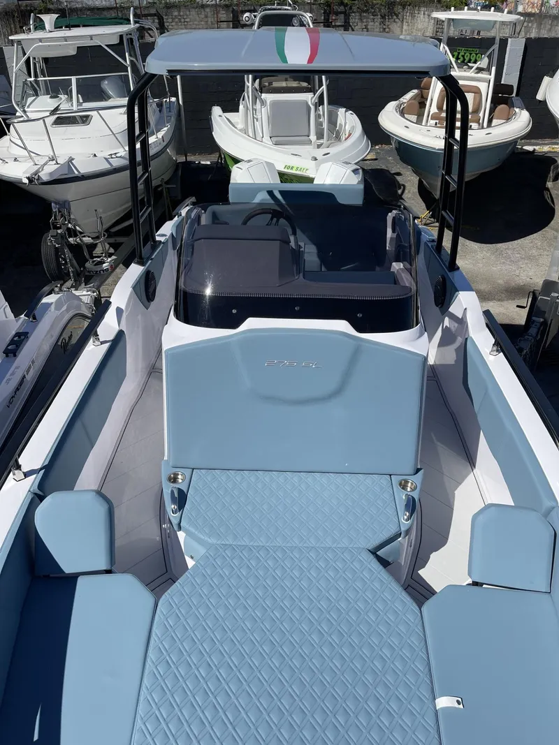 Slide: The Image of 2024 Ranieri 275 SL boat with blue cushioned seating and diamond-pattern upholstery. - 17