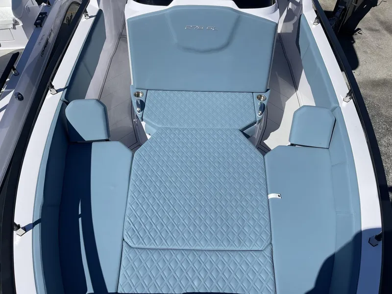 Slide: The Image of 2024 Ranieri 275 SL boat with blue cushioned seating and deck. - 18