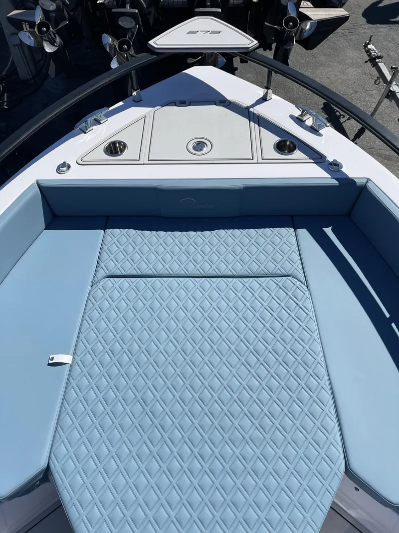 Slide: The Image of 2024 Ranieri 275 SL boat interior with blue seating and modern dashboard. - 19