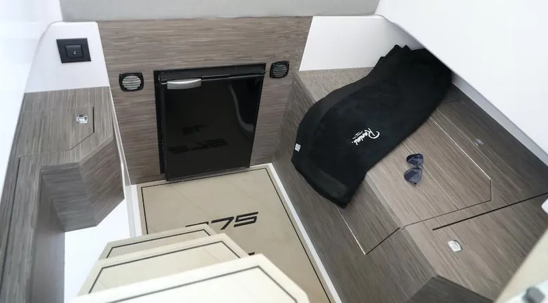 Slide: The Image of Interior cabin of 2024 Ranieri 275 SL boat with modern wood finish and compact amenities. - 2