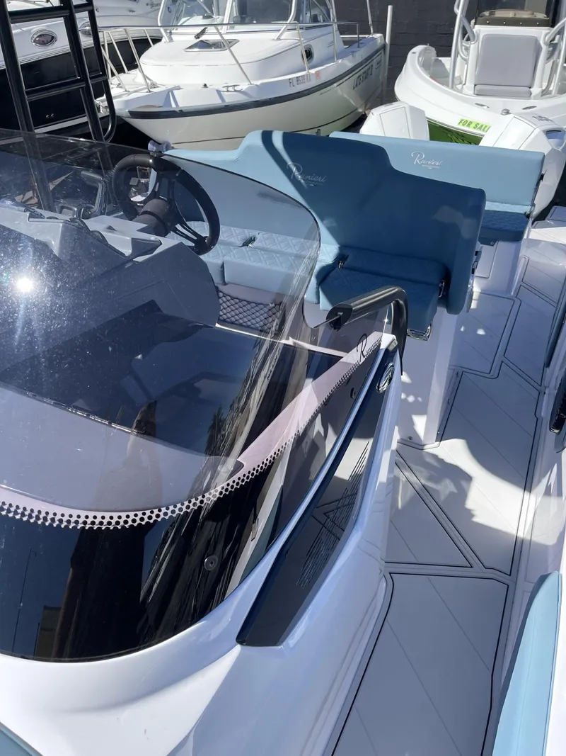 Slide: The Image of 2024 Ranieri 275 SL boat interior with blue and white seating. - 20