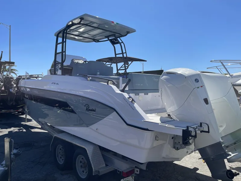 Slide: The Image of 2024 Ranieri 275 SL boat on trailer under clear blue sky. - 31