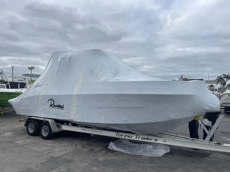 Slide: The Image of 2024 Ranieri 275 SL boat covered in plastic on Torino Trailers. - 5