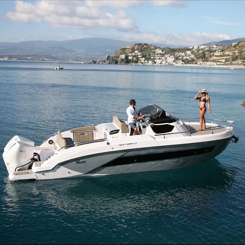 Slide: The Image of 2024 Ranieri 275 SL boat cruising on open water near the coastline. - 8