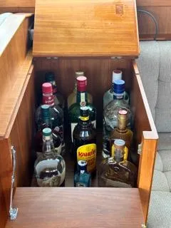 Slide: The Image of Liquor cabinet on 1996 Grand Banks Classic boat, featuring various bottles. - 10