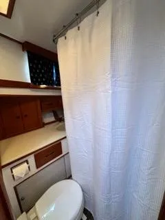 Slide: The Image of Bathroom interior of a 1996 Grand Banks Classic boat with shower and toilet. - 12