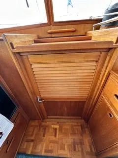Slide: The Image of 1996 Grand Banks Classic interior with wooden louvered door and parquet flooring. - 14