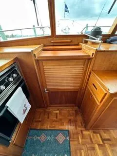 Slide: The Image of Interior of 1996 Grand Banks Classic yacht with wooden cabinetry and nautical decor. - 15
