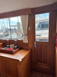 Slide: The Image of Interior view of 1996 Grand Banks Classic yacht with wooden cabinetry and dockside window. - 17