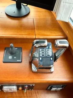 Slide: The Image of 1996 Grand Banks Classic boat controls with joystick and throttle on wooden dashboard. - 18
