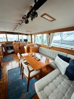 Slide: The Image of Interior of a 1996 Grand Banks Classic yacht with elegant wood furnishings and plush seating. - 2