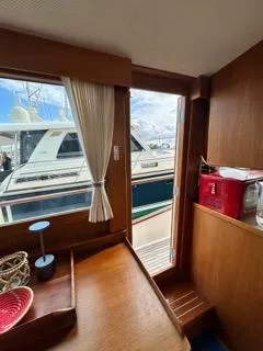 Slide: The Image of Interior view of 1996 Grand Banks Classic yacht with wooden furnishings and dockside view. - 20