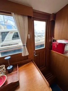 Slide: The Image of Interior of a 1996 Grand Banks Classic yacht with wooden finish and window view. - 21