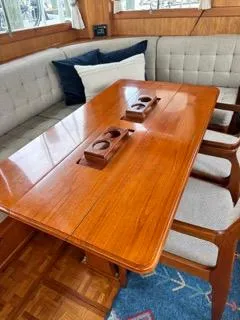 Slide: The Image of Interior of 1996 Grand Banks Classic yacht with wooden table and cushioned seating. - 25