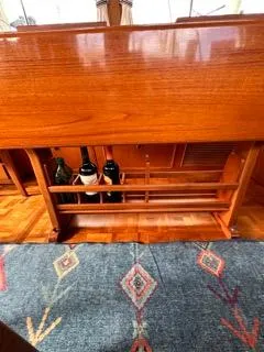 Slide: The Image of 1996 Grand Banks Classic interior with wooden cabinetry and wine storage. - 26