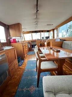 Slide: The Image of Interior of a 1996 Grand Banks Classic yacht with wooden furnishings and a dining area. - 3