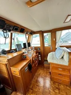 Slide: The Image of Interior of a 1996 Grand Banks Classic boat with wooden helm and seating area. - 30