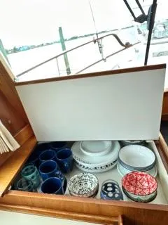 Slide: The Image of 1996 Grand Banks Classic yacht kitchen drawer with assorted dishes and mugs. - 32