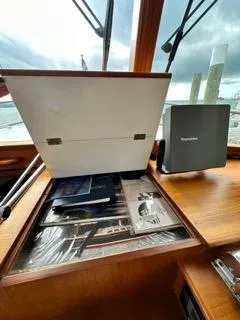 Slide: The Image of 1996 Grand Banks Classic boat interior with open storage compartment and navigation equipment. - 35