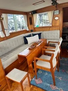 Slide: The Image of Interior of 1996 Grand Banks Classic yacht with elegant seating and wooden furnishings. - 4