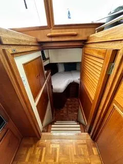 Slide: The Image of Interior view of 1996 Grand Banks Classic yacht with wooden finishes and cozy cabin. - 42