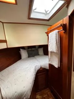 Slide: The Image of Cozy cabin interior of 1996 Grand Banks Classic yacht with skylight and wooden finishes. - 43