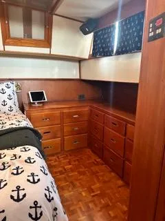 Slide: The Image of Interior of 1996 Grand Banks Classic yacht with anchor-themed bedding and wooden cabinetry. - 48