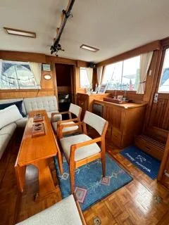 Slide: The Image of Interior of 1996 Grand Banks Classic yacht with wooden furnishings and seating area. - 5