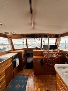 Slide: The Image of Interior of a 1996 Grand Banks Classic yacht with wooden helm and panoramic windows. - 6