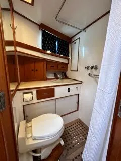 Slide: The Image of 1996 Grand Banks Classic yacht bathroom with wooden cabinetry and nautical decor. - 9