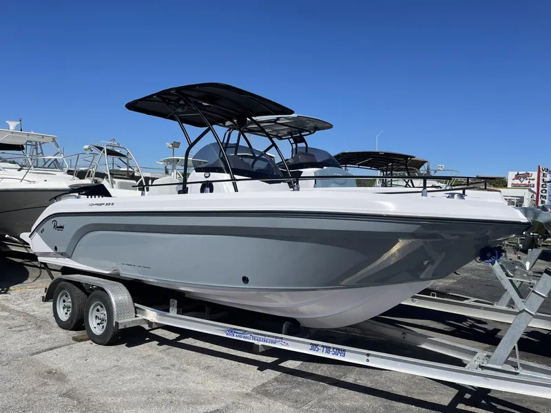 Slide: The Image of 2024 Ranieri 23S boat on a trailer, side view, in a marina. - 1