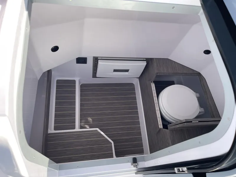 Slide: The Image of 2024 Ranieri 23S boat interior with modern flooring and compact toilet. - 10