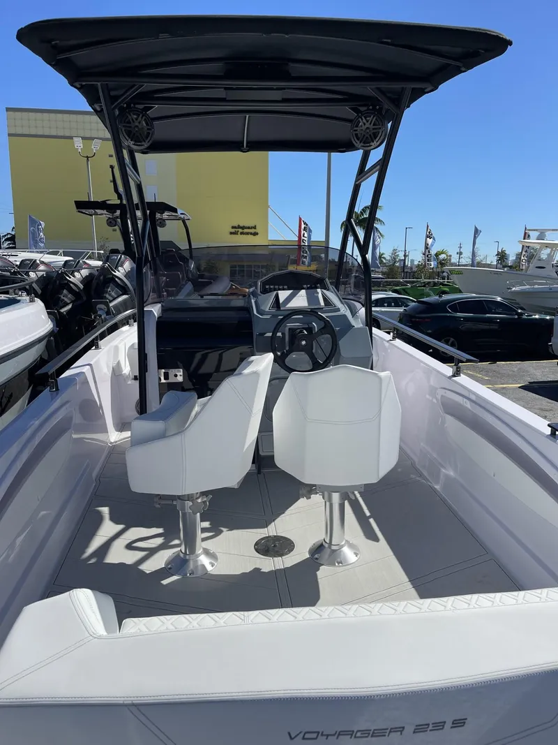 Slide: The Image of 2024 Ranieri Voyager 23S boat with white interior and black canopy. - 11