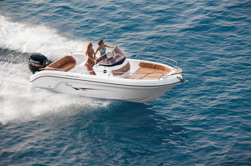 Slide: The Image of 2024 Ranieri 23S boat cruising on blue water. - 17