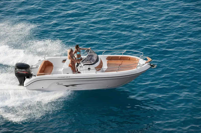 Slide: The Image of 2024 Ranieri 23S motorboat cruising on clear blue water. - 19