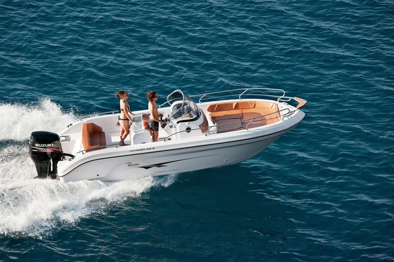 Slide: The Image of 2024 Ranieri 23S motorboat cruising on the ocean with two people onboard. - 21