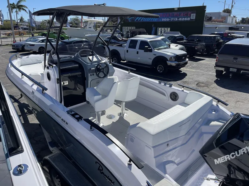 Slide: The Image of 2024 Ranieri 23S boat with Mercury engine, white interior, and black canopy. - 4