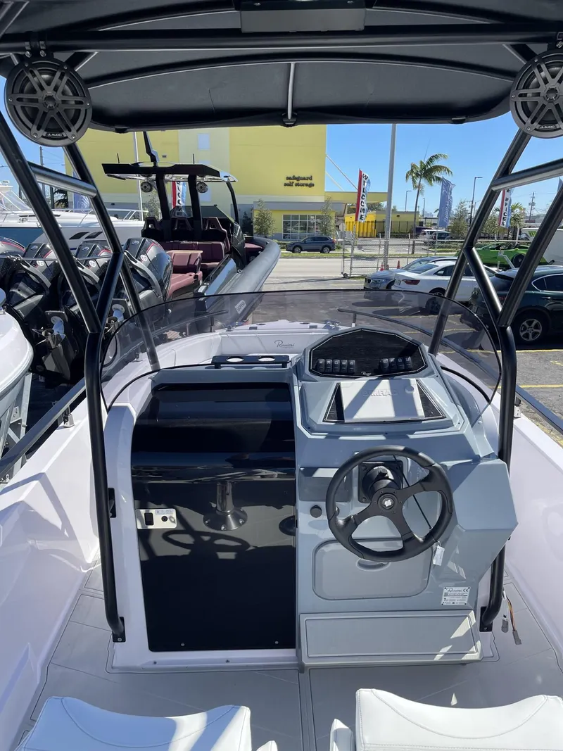 Slide: The Image of 2024 Ranieri 23S boat interior with steering wheel and control panel. - 6