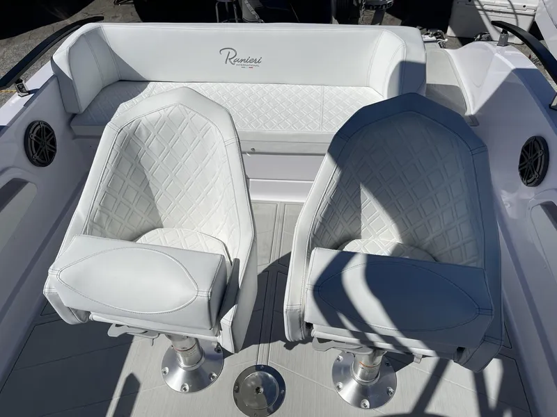 Slide: The Image of 2024 Ranieri 23S boat interior with white leather seats and diamond stitching. - 9