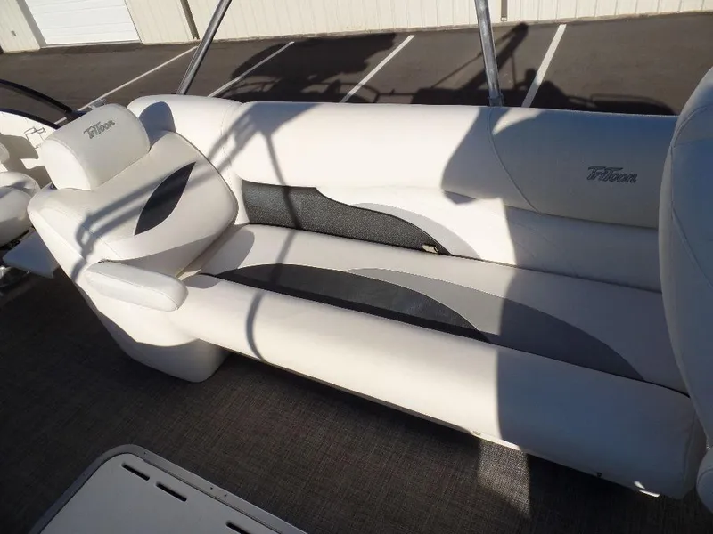 Slide: The Image of 2017 JC Sporttoon 28TT boat interior with white and gray seating. - 12