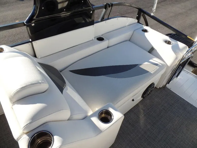 Slide: The Image of 2017 JC Sporttoon 28TT boat interior with white cushioned seating and cup holders. - 17