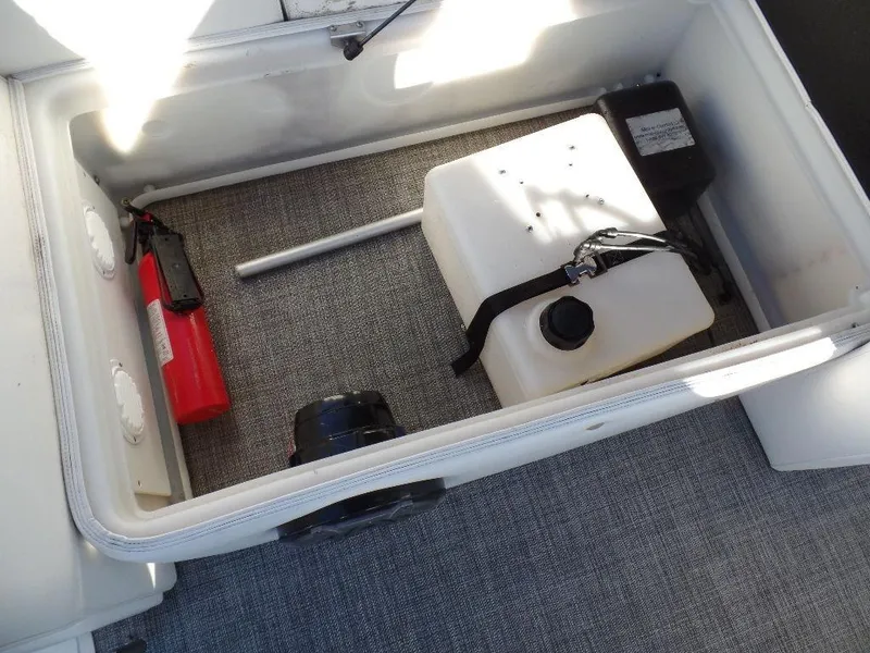 Slide: The Image of Storage compartment of 2017 JC Sporttoon 28TT with fire extinguisher and fuel tank. - 18