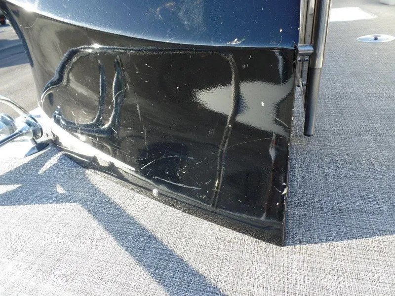 Slide: The Image of Close-up of a 2017 JC Sporttoon 28TT boat with visible hull damage. - 31