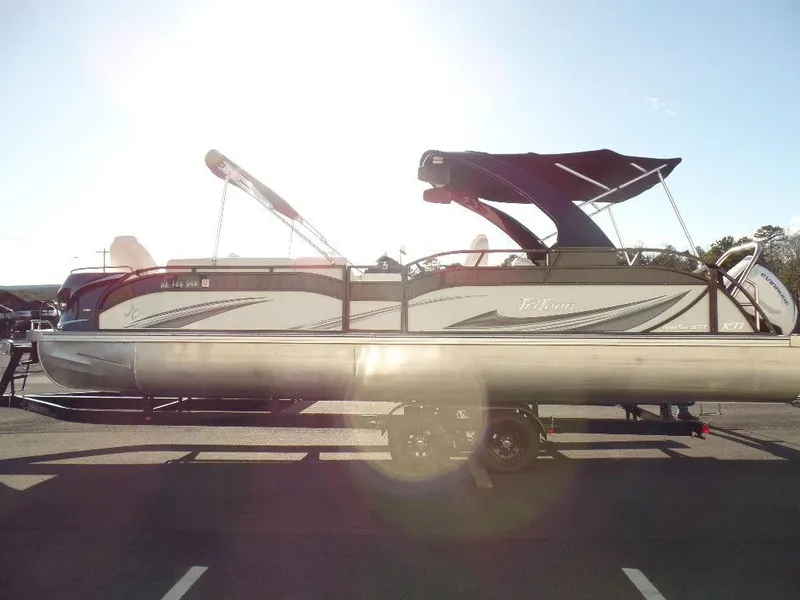 Slide: The Image of 2017 JC Sporttoon 28TT pontoon boat on a trailer in a parking lot. - 5