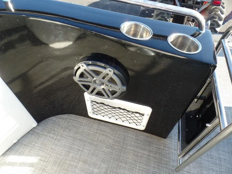 Slide: The Image of 2017 JC Sporttoon 28TT boat interior with speaker, cup holders, and storage. - 8