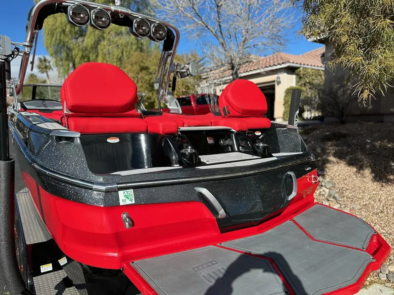 Slide: The Image of 2020 MasterCraft X24 boat with red and black seating, rear view. - 5