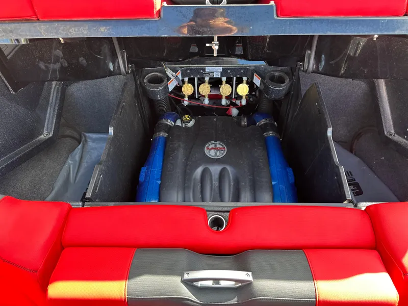Slide: The Image of 2020 MasterCraft X24 boat engine compartment with red and black interior. - 7