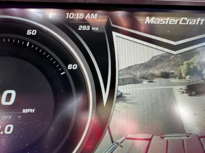 Slide: The Image of MasterCraft X24 2020 dashboard display showing 293 hours and 10:18 AM. - 8