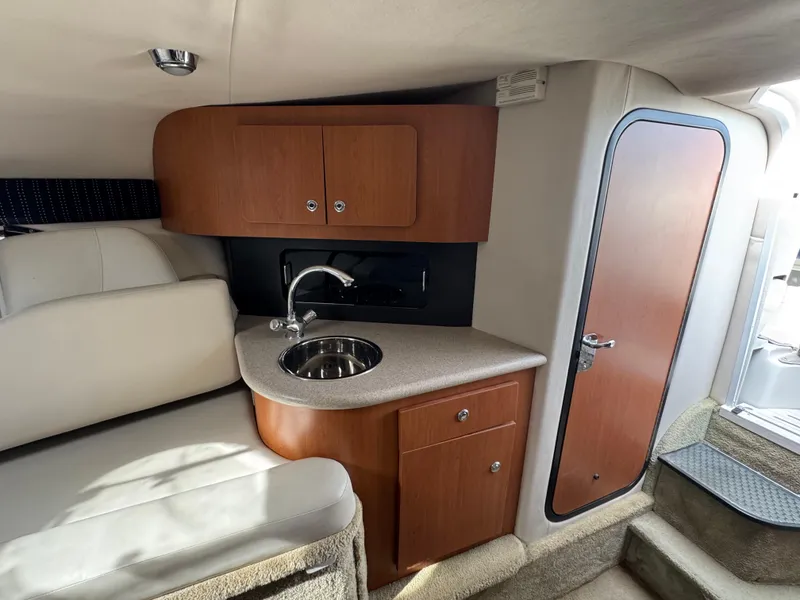 Slide: The Image of 2008 Crownline 315 SCR cabin interior with kitchenette and seating area. - 20